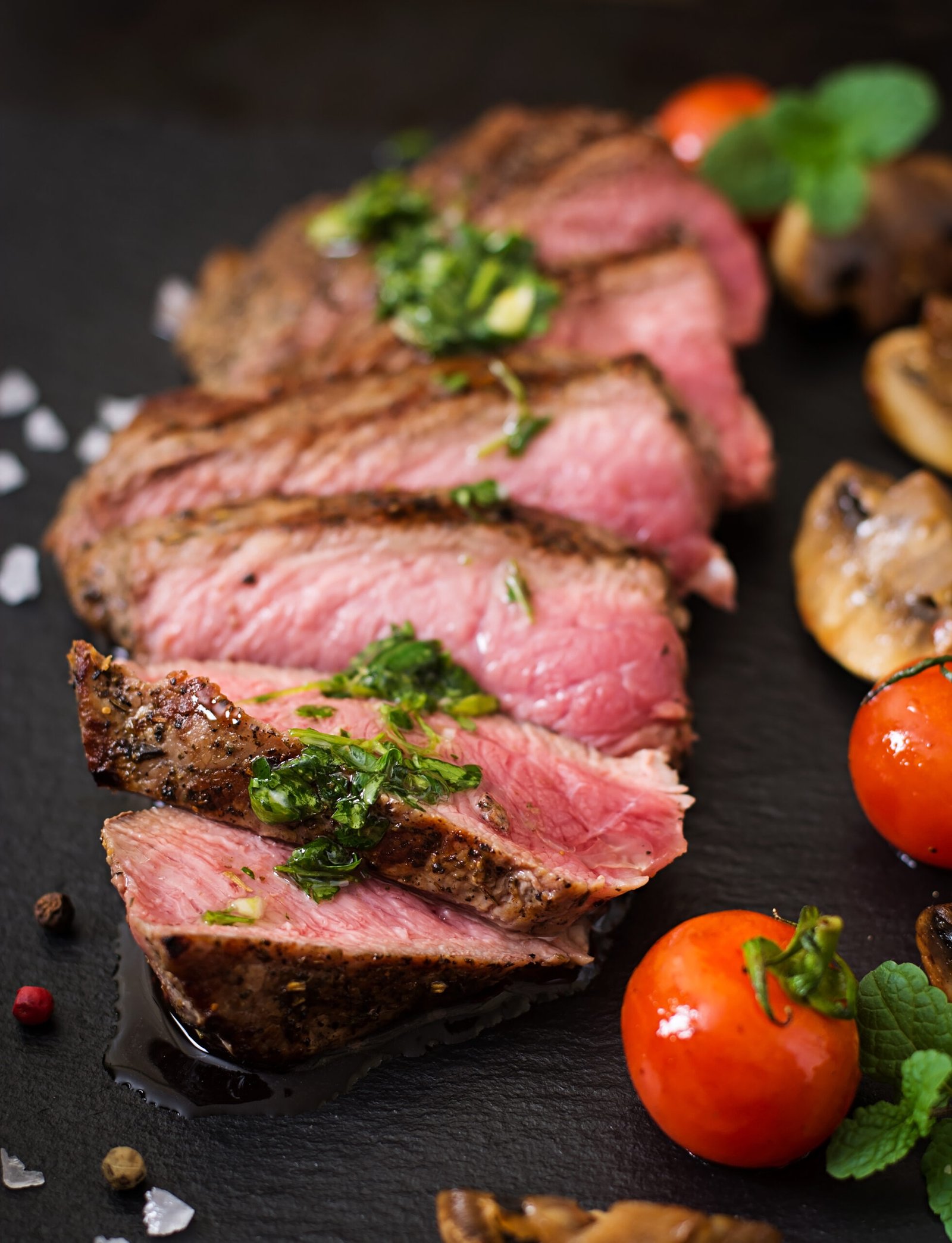 juicy steak medium rare beef with spices and grilled vegetables. Chuleton de ternera